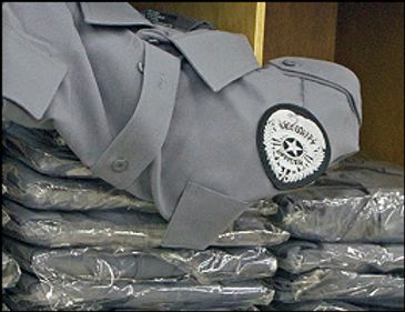 Stacked industrial uniform jackets with badge